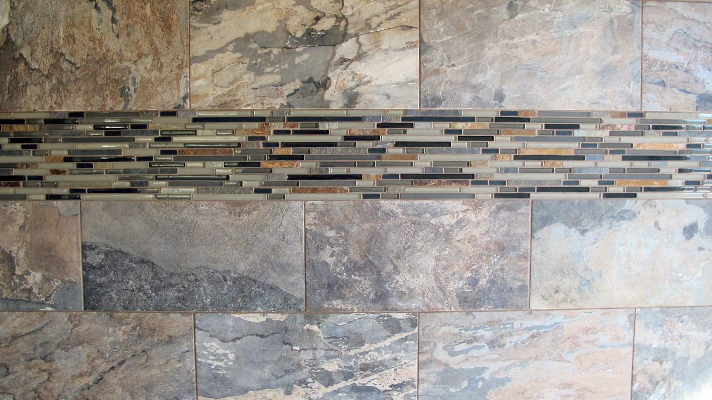 Shower wall tile Thompson Tile & Stone Olympia Geology porcelain 12x24 slate  soil rustic glass mosaic linear thick border 