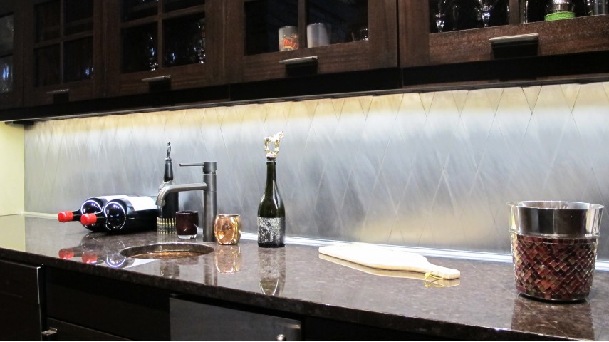 Bar Backsplash with under cabinet lighting recycled metal tile rhomboid wine storage solid surface countertop