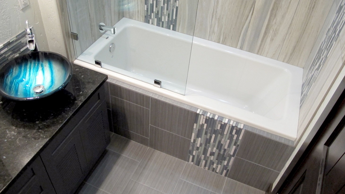 Contemporary modern stylish bathroom guest bath modern vanity vessel sink blue aqua iridescent Flow linear tile porcelain ceramic color body glass mosaics decorative border backsplash cabinets chrome shower tub Thompson Tile Cronin Blends S'tile Sky 