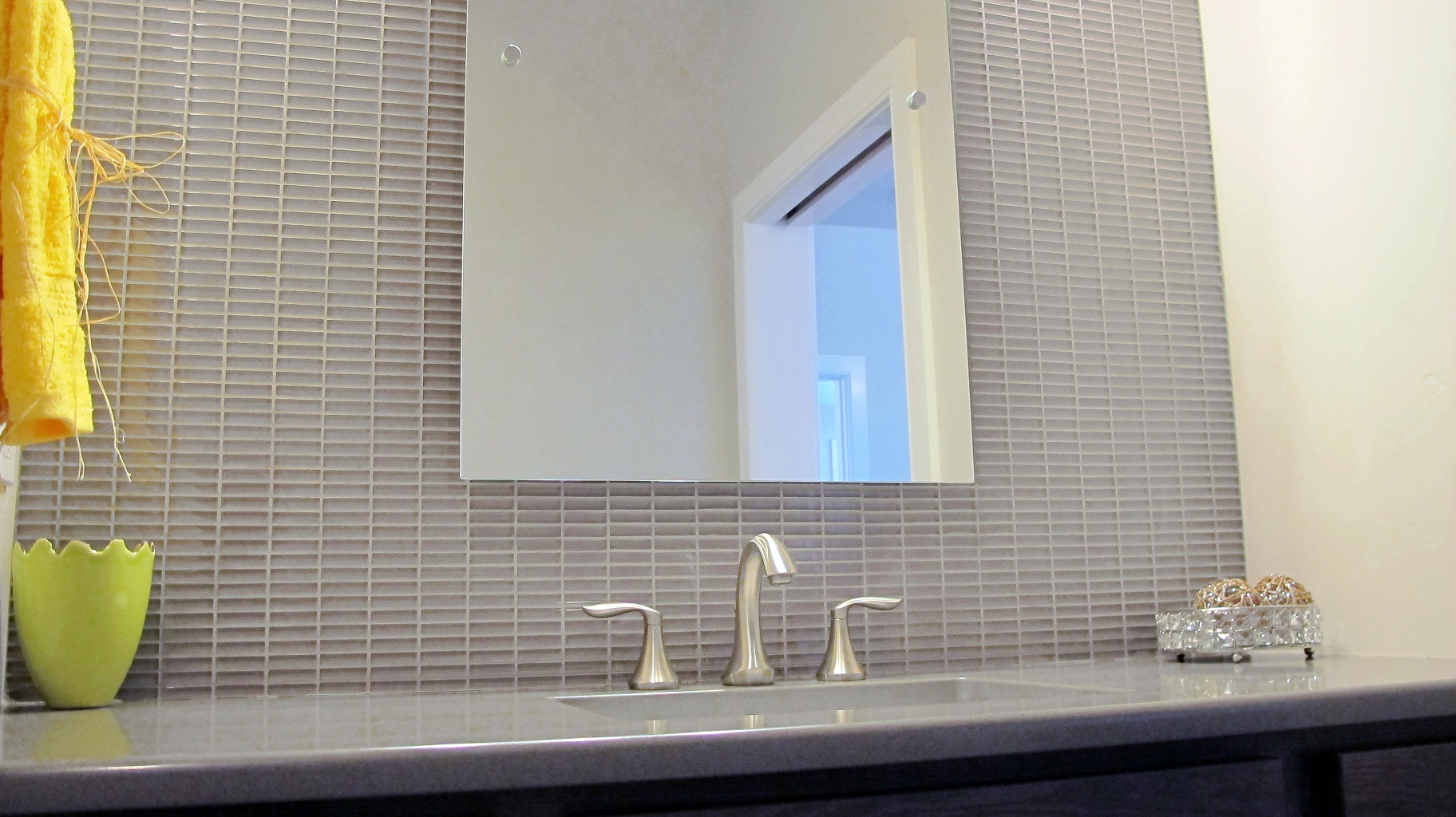 Master bathroom vanity quartz counter top under mount sink brushed nickel faucet floating mirror over full wall custom glass tile backsplash cristallo glass thompson tile olympia stacked mirror reflection brushed nickel undermount sink