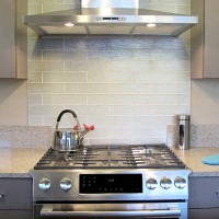 Kitchen back splash glass 3x12 subway stagger white glossy stainless steel range and hood arctic grey cabinets huntwood gas tea kettle quartz lg Viatera