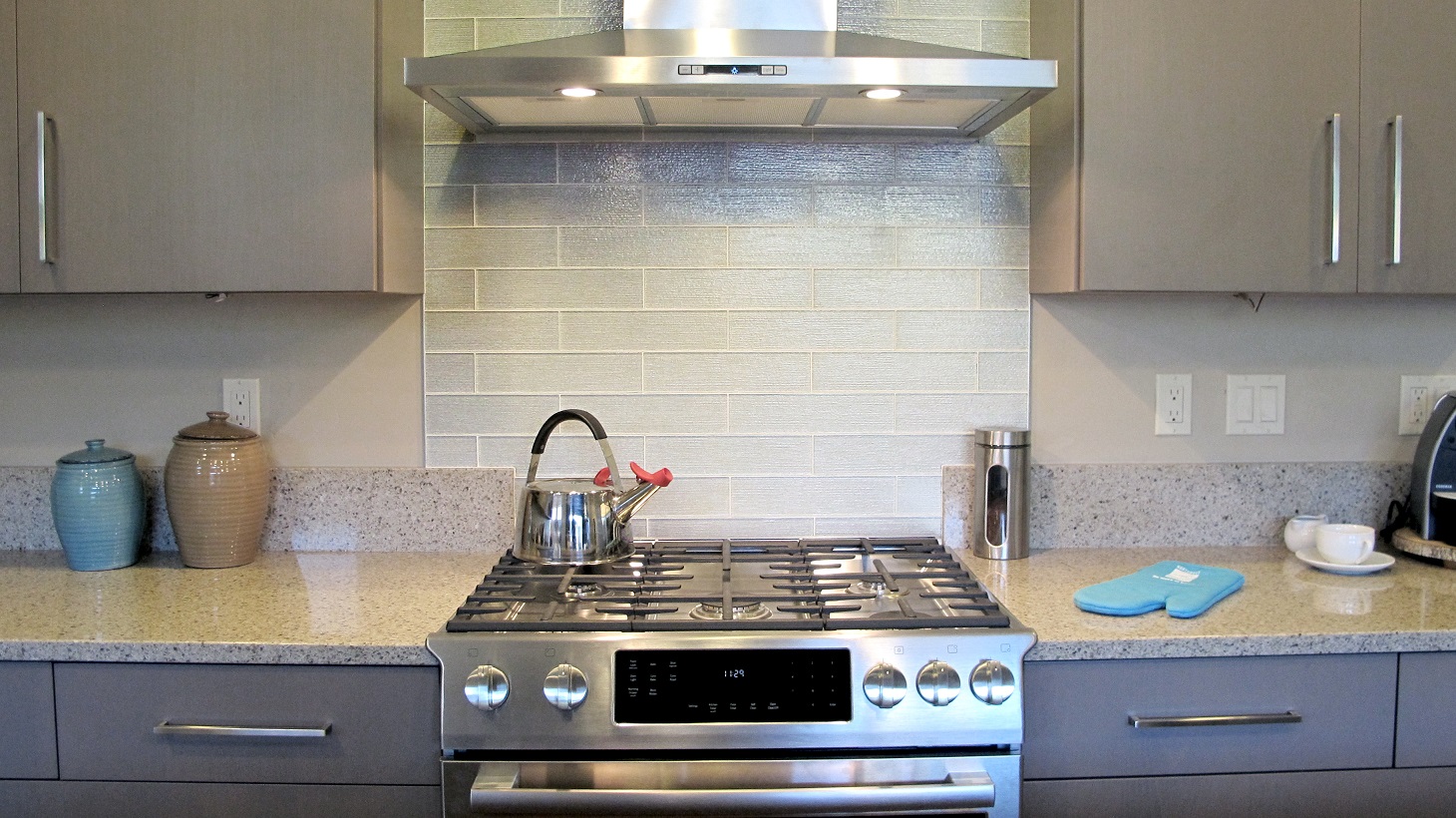 Kitchen back splash glass 3x12 subway stagger white glossy stainless steel range and hood arctic grey cabinets huntwood gas tea kettle quartz lg Viatera