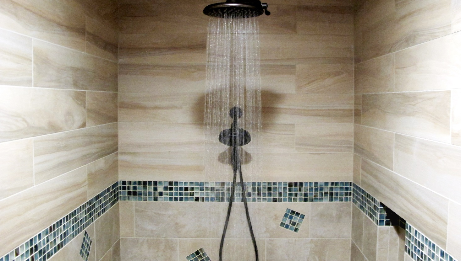 Large walk in steam shower decorative glass band border mosaic oceanside blue beach coastal tabula miele beige cream soft wood grain plank 6x36 tozen 1x1 oxygen silkl rain shower head water relaxing tranquil